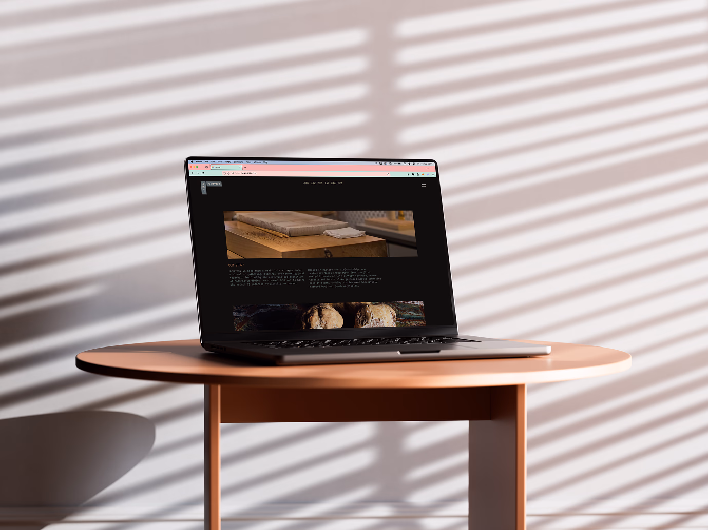The Sukiyaki site open on a laptop, showing the story section between two photographs